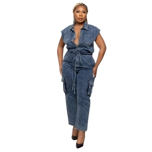 Detail view of dark blue denim jumpsuit featuring front buttons and cargo pockets