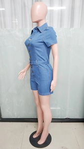 Side view of short sleeve denim romper featuring button closure and matching belt
