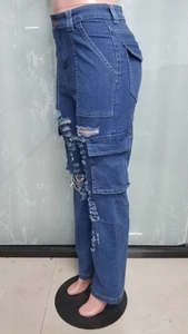 Detail view of high waist cargo jeans featuring side pockets and distressed ripped denim