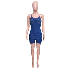 Detail of slim-fit dark blue denim romper with sparkling rhinestone vertical stripes