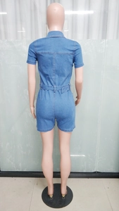 Back view of slim fit blue denim short jumpsuit with waist belt on mannequin