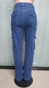 Detailed back view of high-waisted blue cargo jeans with functional flap pockets and loose fit
