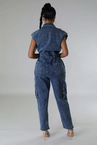 Rear view of a slim fit denim jumpsuit featuring elastic waist and large cargo pockets
