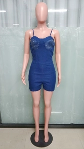 Detail of slim fit dark blue denim romper with silver rhinestones on the chest area