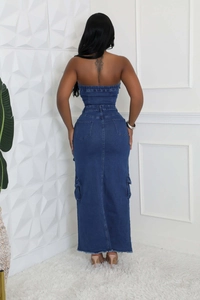 Detail of slim-fit denim tube dress featuring back pockets and distressed frayed hemline