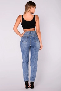Back view of high waisted distressed blue jeans with ripped detail and pockets