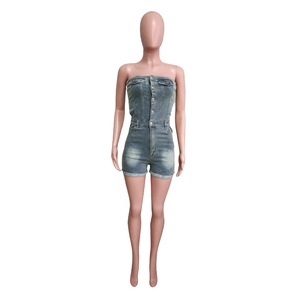 Detail of light blue washed denim strapless romper featuring front buttons and side pockets