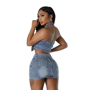 Detailed view of women's denim set featuring back pockets and frayed hem skirt
