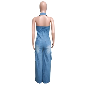 Detail of light blue washed denim jumpsuit featuring back pockets and cargo side pockets