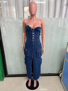 Detail view of denim tube dress featuring front buttons and large cargo zipper pockets