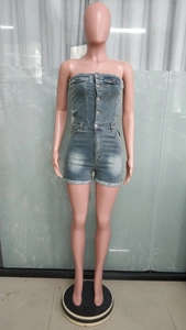 Detail view of denim tube romper showing front buttons, pockets and cuffed hem features