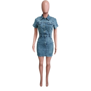 Close-up detail of light blue denim mini dress featuring front buttons and chest pockets