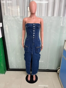 Detail of cargo pockets and metal buttons on strapless denim dress with front slit