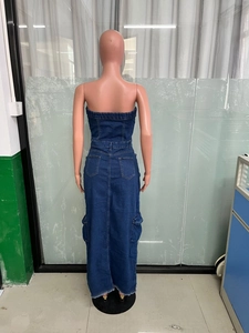 Detailed back view of a strapless denim maxi dress featuring utility pockets and raw hem edges