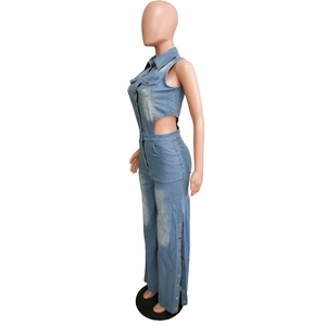 Détail d'une combinaison en jean avec découpes à la taille et boutons en métal sur les jambes