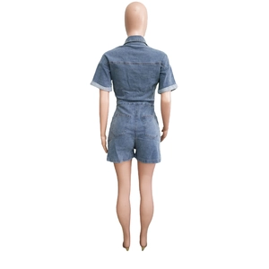 Rear view of washed blue denim romper with short sleeves and back pockets detailing