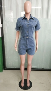 Detail of short sleeve denim jumpsuit featuring turn-down collar and chest pockets