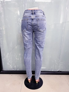 Rear view of slim fit light blue denim jeans for women with back pocket detail