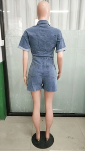 Back view of short sleeve denim jumpsuit featuring contrast stitching and rear pockets