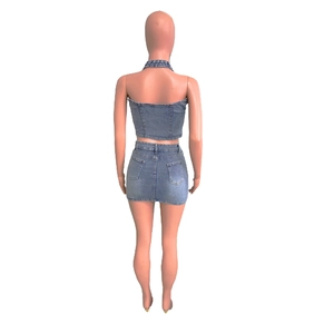 Rear view of two-piece denim set with halter crop top and skirt featuring cross embroidery