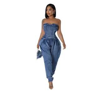 Detailed view of strapless denim jumpsuit featuring waist pockets and pleated harem pants