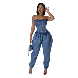Detail showing structured corset bodice and pleated pockets of the blue denim jumpsuit