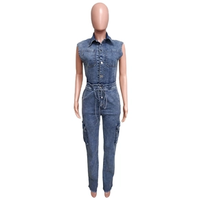 Detail view of denim jumpsuit featuring turn-down collar, chest pockets and drawstring waist