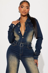Detail of vintage blue denim jumpsuit with long sleeves, metal buttons and waist belt