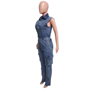Detail of denim jumpsuit showing sleeveless design with drawstring waist and cargo pockets