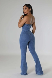 Detail of metal back zipper closure on tube top denim jumpsuit with flare leg cut