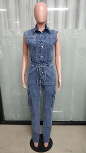 Detail of blue washed denim jumpsuit featuring chest pockets and drawstring waist design