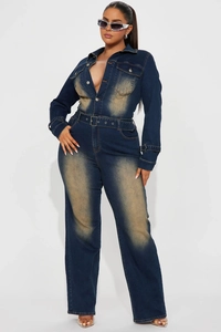 Detail of slim fit denim jumpsuit featuring vintage wash and silver metal buckle belt