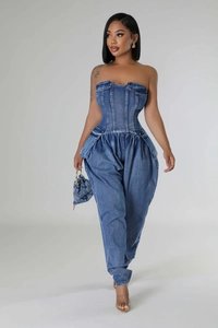 Detail of slim fit denim tube jumpsuit featuring corset waist and side cargo pockets