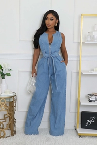 Close-up of light blue sleeveless denim jumpsuit with center zipper and waist tie