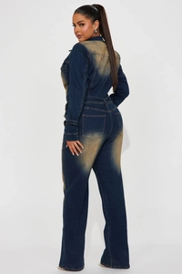 Detail of vintage washed denim jumpsuit featuring back pockets and retro yellow fading effects