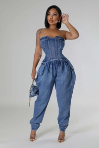 Detail of strapless denim jumpsuit with cinched waist and hourglass silhouette design