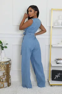 Rear view of light blue denim jumpsuit with waist tie and wide leg silhouette