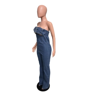 Detail of blue strapless denim jumpsuit with a wide buckled waist belt and flare leg cut