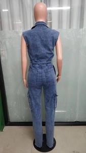 Detail view of the back of blue denim sleeveless jumpsuit with waist-cinching and frayed hems