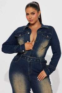 Detail of slim fit denim jumpsuit featuring washed texture and metal buttons with belt