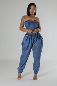Detail showing the slim-fit denim tube jumpsuit with bone corset and cargo pockets