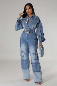 Close-up of washed denim jumpsuit featuring cargo pockets and adjustable wide buckle belt