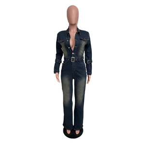 Detail of slim-fit blue denim jumpsuit featuring waist belt and metal buckle