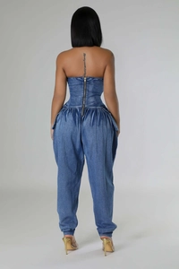 Detailed back view of a denim strapless jumpsuit showing the high-stretch waist and long zipper