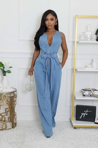 Detail of light blue sleeveless denim jumpsuit with front zipper and waist tie belt