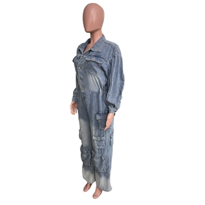 Side view of washed blue denim boilersuit with cargo pockets on white background