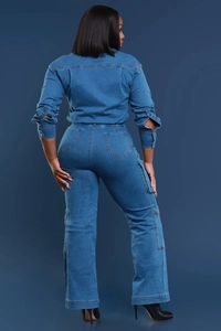 Detail view of washed blue denim jumpsuit back with cargo pockets and split sleeve cuffs