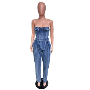 Detail of slim fit strapless denim jumpsuit with flap pockets and structured stitching