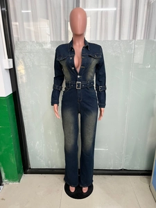 Detail of slim fit denim jumpsuit featuring button placket and waist belt with square buckle