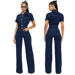 Detail of dark blue denim jumpsuit featuring contrast white stitching and wide leg design